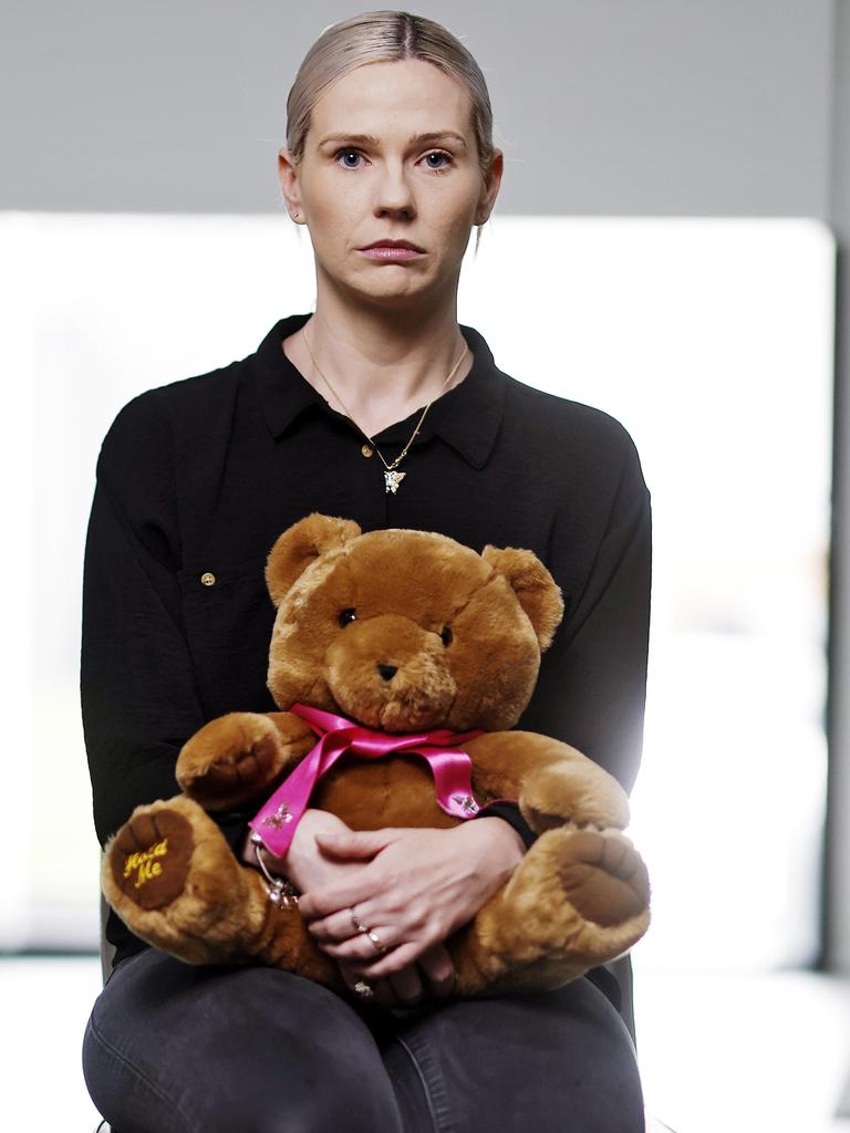 Kelly O’Brien hugging a bear stuffed with Charlotte’ ashes. Picture: Sam Ruttyn