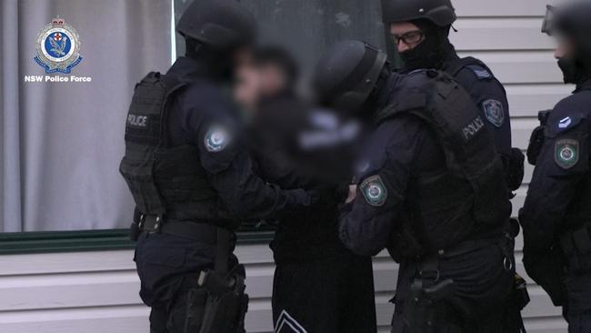 19-year-old Dani Mansour was led outside and spoke with police before his arrest. Picture: NSW Police