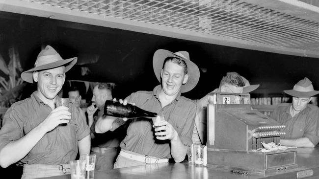 Soldiers enjoy a beer to mark the end of World War II