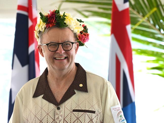 Australian Prime Minister Anthony Albanese wears a floral head piece while signing agreements with Prime Minister of Tuvalu Feleti Teo for the Australia-Tuvalu Falepili Union to come into force at the 53rd Pacific Islands Forum Leaders Meeting in Nuku'alofa, Tonga, Wednesday, August 28, 2024. Leaders from Pacific Island nations are gathering in Tonga for the 53rd Pacific Islands Forum Leaders Meeting. (AAP Image/Lukas Coch) NO ARCHIVING