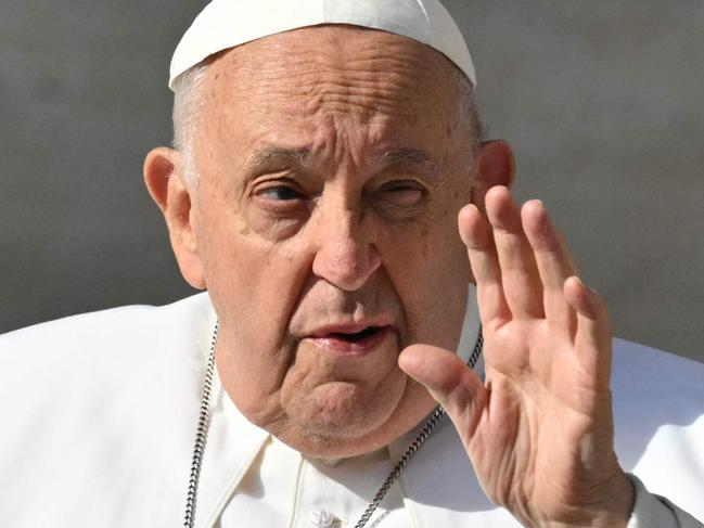 Pope Francis waves to the crowd as he arrives for the weekly general audience on May 15, 2024 at St Peter's square in The Vatican. (Photo by Andreas SOLARO / AFP)