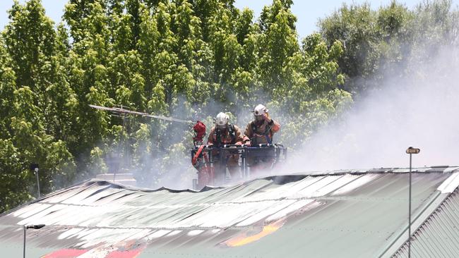 Firefighters on the roof at Grumpy’s. Picture: Dylan Coker