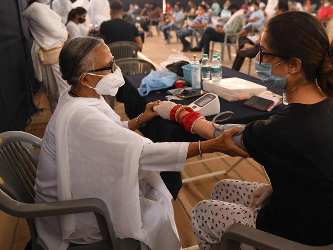 A woman gets her blood pressure checked before getting inoculated in Amritsar, India. Picture: AFP