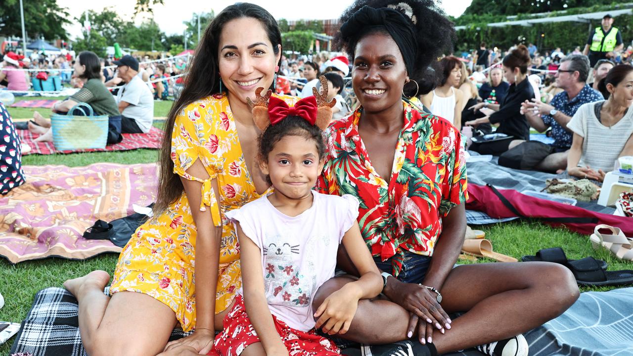 Zoe Wicks, Ariana Cunllife, 6, and Carolyne Yakase at the Carols in the Park, held at Munro Martin Parklands. Picture: Brendan Radke