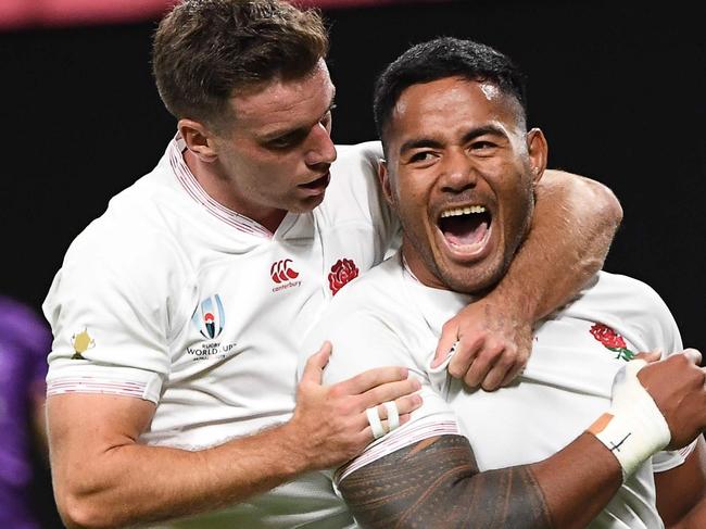 England's centre Manu Tuilagi (R) celebrates with England's fly-half George Ford after scoring a try during the Japan 2019 Rugby World Cup Pool C match between England and Tonga at the Sapporo Dome in Sapporo on September 22, 2019. (Photo by WILLIAM WEST / AFP)