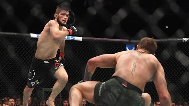 Khabib Nurmagomedov (L) rushes towards Conor McGregor during their lightweight championship. Picture: AFP