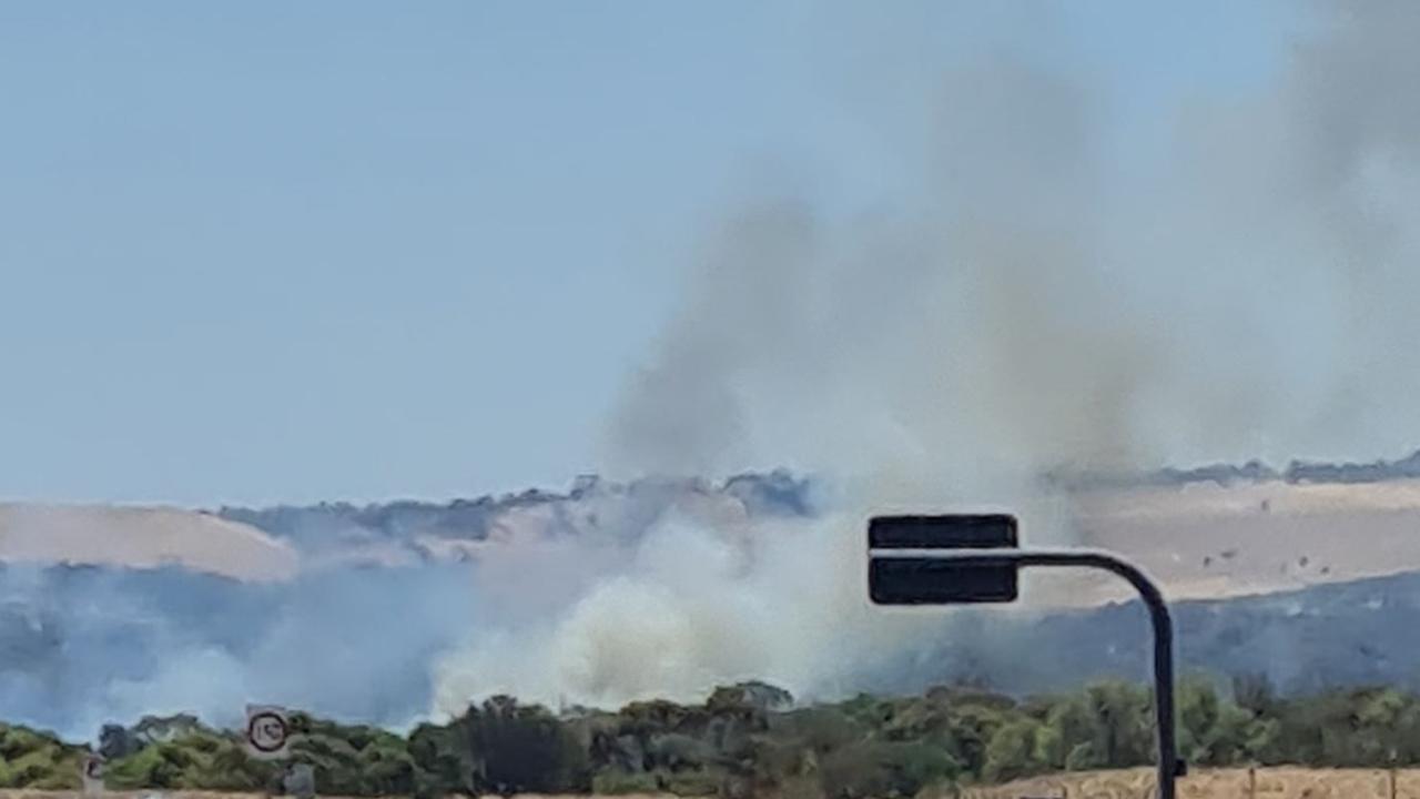 Smoke warning: Fire threatening homes near major shopping centre