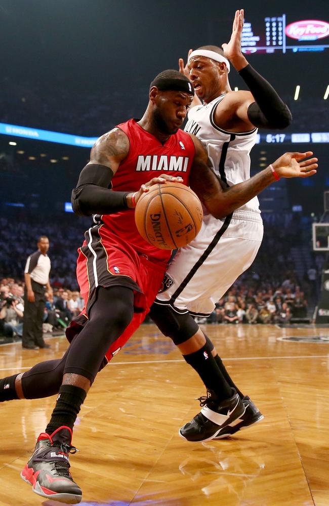 Miami Heat forward LeBron James (6) takes off his shoes after the game  against New Jersey Nets at the Prudential Center. The Heat beat The Nets,  108-94.