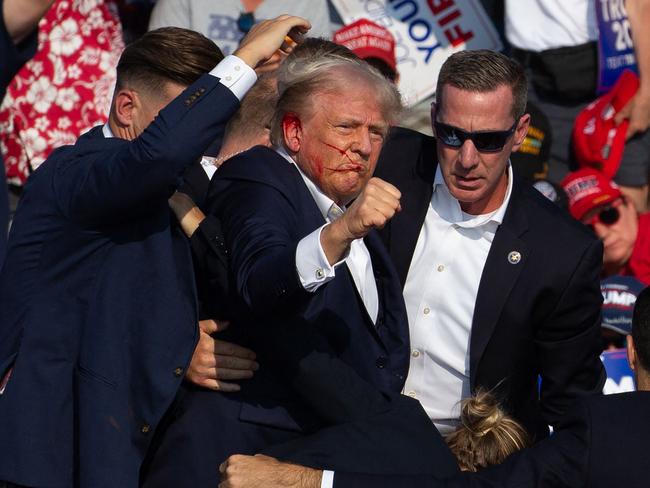 US Republican candidate Donald Trump gives his iconic fist pump after being shot. Picture: AFP