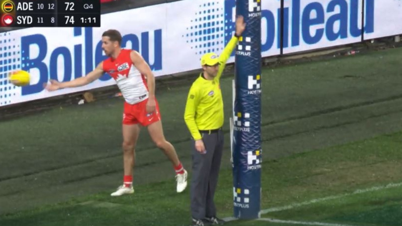 The umpire signals the ball hit the post. Picture: Fox Sports