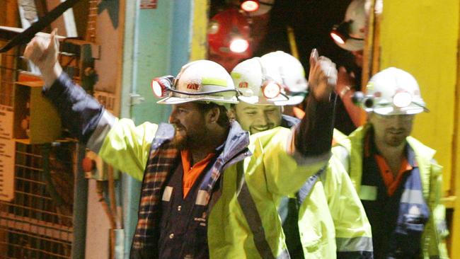 Tasmanian miners Todd Russell, left, Brant Webb, second left, wave as they emerge from the mine lift after their rescue in 2006. Picture: Getty