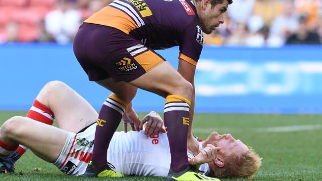 Andrew McCullough of the Broncos assists James Graham as he lies concussed during the 2018 elimination final.