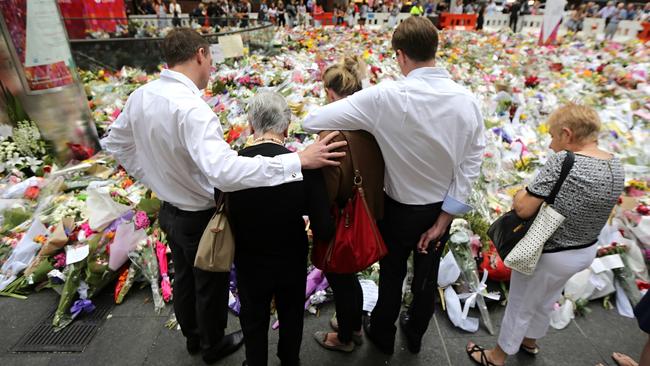 Family members of Katrina Dawson visit a memorial three days after the siege at Lindt cafe in Martin Place. Picture: John Grainger