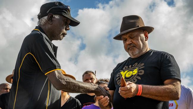 Balupalu Yunupingu gives a message stick to Noel Pearson. Picture: Tamati Smith/Getty Images