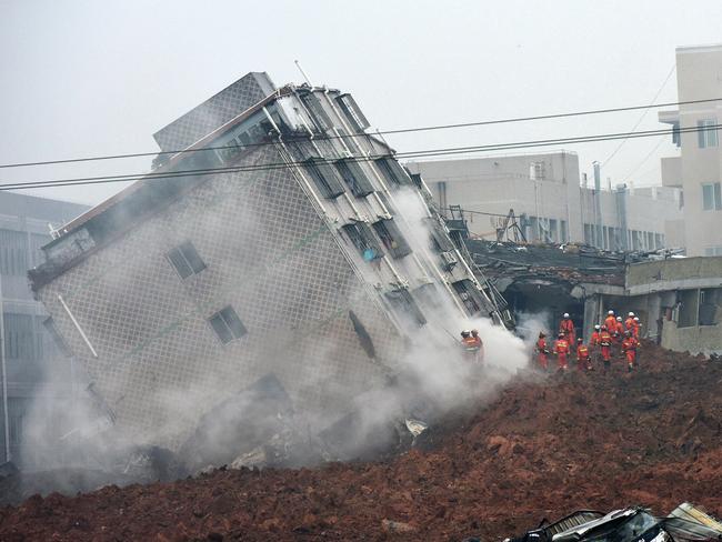 Rescuers search for survivors ... a collapsed building following the landslide. Picture: Chinatopix via AP
