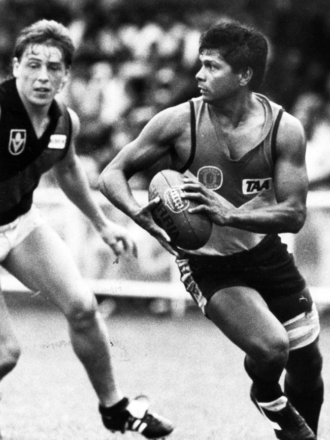 Thompson during his playing career, chasing Maurice Rioli.