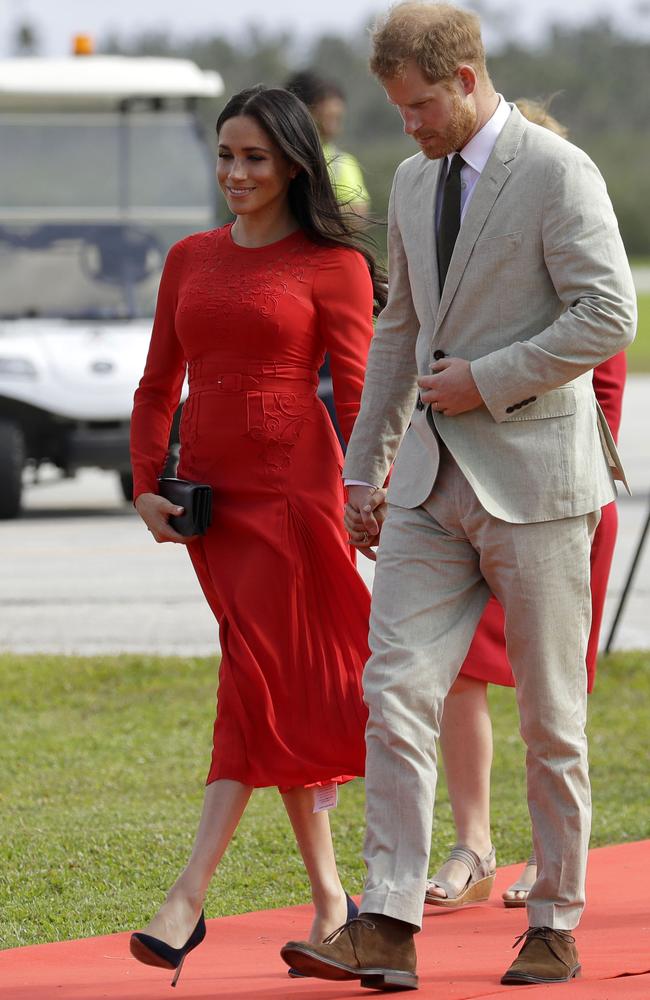 The Duchess of Sussex arrives in Tonga with a visible dress tag. Picture: AP