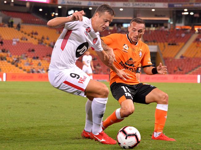 BRISBANE, AUSTRALIA - MARCH 08: Oriol Riera of the Wanderers and  Eric Bautheac of the Roar challenge for the ball during the round 21 A-League match between the Brisbane Roar and the Western Sydney Wanderers at Suncorp Stadium on March 08, 2019 in Brisbane, Australia. (Photo by Bradley Kanaris/Getty Images)