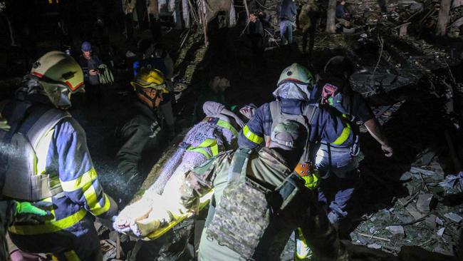 Ukrainian rescuers carry a wounded local resident after the Russian missile attack on Kyiv. Picture; AFP.