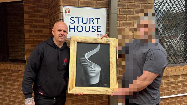 A Macquarie Correctional Centre inmate has donated art to Sturt House to raise money for a Youth Foyer in Dubbo. Left is Sturt House manager Jamie Butcher. Photo: Tijana Birdjan