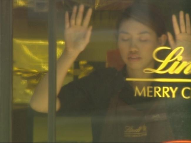 Elly Chen forced to stand in a Lindt café window during the siege. Photo courtesy of Seven News