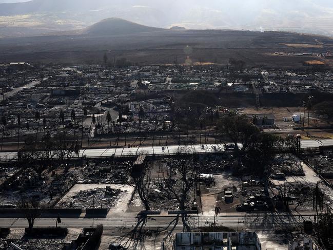 LAHAINA, HAWAII - AUGUST 11: In an aerial view, homes and businesses are seen that were destroyed by a wildfire on August 11, 2023 in Lahaina, Hawaii. Dozens of people were killed and thousands were displaced after a wind-driven wildfire devastated the town of Lahaina on Tuesday. Crews are continuing to search for missing people.   Justin Sullivan/Getty Images/AFP (Photo by JUSTIN SULLIVAN / GETTY IMAGES NORTH AMERICA / Getty Images via AFP)