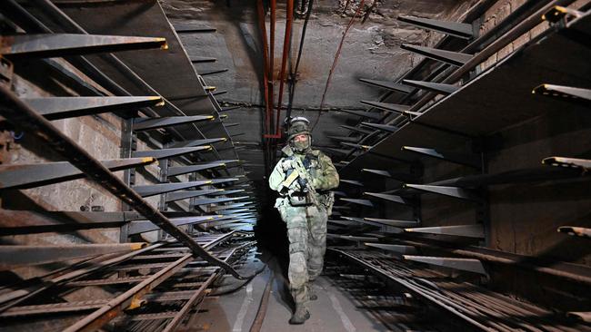 A Russian serviceman inspects an underground tunnel under the Azovstal steel plant in the destroyed city of Mariupol. Picture: AFP