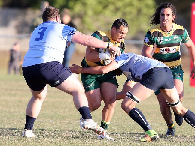 Helensvale defenders wrap up Surfers Paradise’s Dalin Sharrock. Picture: Richard Gosling