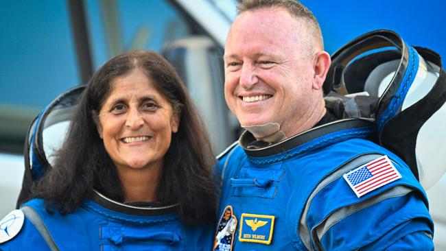 (FILES) NASA astronauts Butch Wilmore (R) and Suni Williams, wearing Boeing spacesuits, depart the Neil A. Armstrong Operations and Checkout Building at Kennedy Space Center for Launch Complex 41 at Cape Canaveral Space Force Station in Florida to board the Boeing CST-100 Starliner spacecraft for the Crew Flight Test launch , on June 5, 2024. Two astronauts stranded in space may sound like the start to a big-screen science thriller, but the Boeing Starliner mission is no work of Hollywood fiction. Astronauts Barry "Butch" Wilmore and Sunita "Suni" Williams were originally scheduled to spend a little more than a week aboard the International Space Station as part of the debut crew flight test of the Starliner. However, the spacecraft encountered several issues during the flight, and now the two astronauts will likely have to extend their stay aboard the ISS for several months. (Photo by Miguel J. Rodriguez Carrillo / AFP)