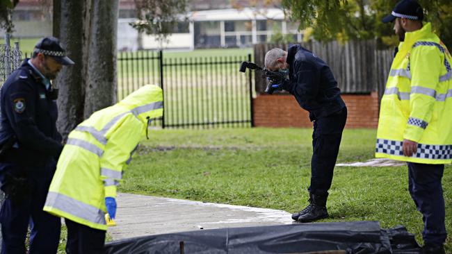 Police on the scene of the stabbing where three men have been taken to hospital at Old Saleyards reserve in North Parramatta. Picture: Adam Yip