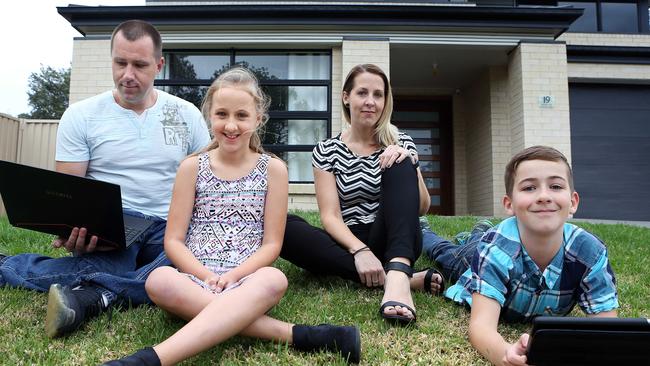 Benjamin and Rachel Stewart with their children Olivia, 9, and Daniel, 11, at their NSW Central Coast home. Picture: James Croucher