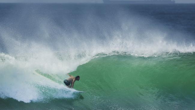 A surfer takes on a large wave at Sunshine Beach as big swells are forecast to pound southeast Queensland over the next week. Picture Lachie Millard