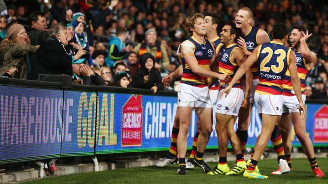 Eddie Betts celebrates — near Port fans — with teammates after he kicked a goal during the Showdown. Picture: Morne de Klerk/Getty Images