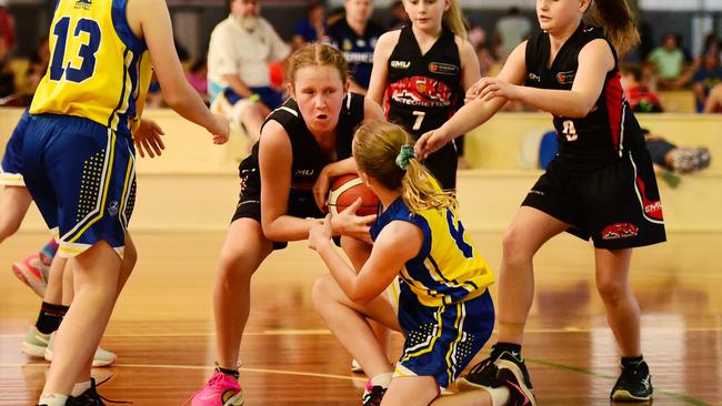 Queensland North Junior Championships in Townsville. U12's Townsville Flames Vs Mackay Meteorettes. Mackay's Skye Vaughan and Flames Sofia Blanco-Boyle wrestle over the ball. Picture: Alix Sweeney