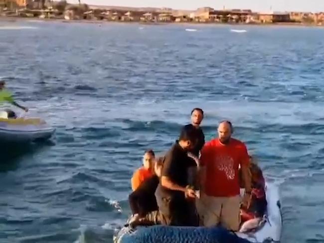 A video grab shows rescue workers helping tourists and crew members. Picture: Red Sea governor’s office / AFP