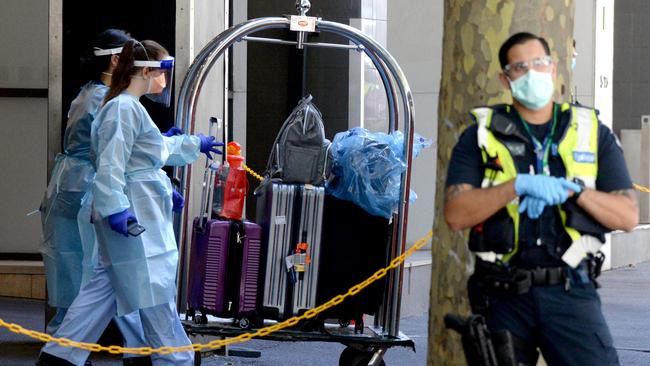 MELBOURNE, AUSTRALIA - NewsWire Photos FEBRUARY 16, 2021: Luggage belonging to quarantined international travellers is loaded onto a coach outside the Holiday Inn on Flinders Lane to be transported to the Pullman Albert Park. Picture: NCA NewsWire / Andrew Henshaw