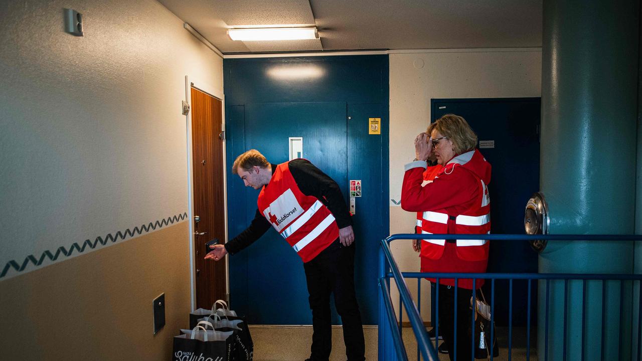 Swedish Red Cross volunteers deliver goods to elderly residents in Nacka, near Stockholm, to protect them from exposure to the coronavirus. Picture: AFP