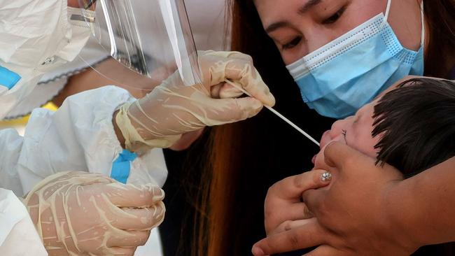 A child receives a nucleic acid test for Covid-19 in Zhengzhou, in China's central Henan province. Picture: AFP