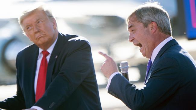 Donald Trump listens as Nigel Farage speaks during a Make America Great Again rally. Picture: AFP.