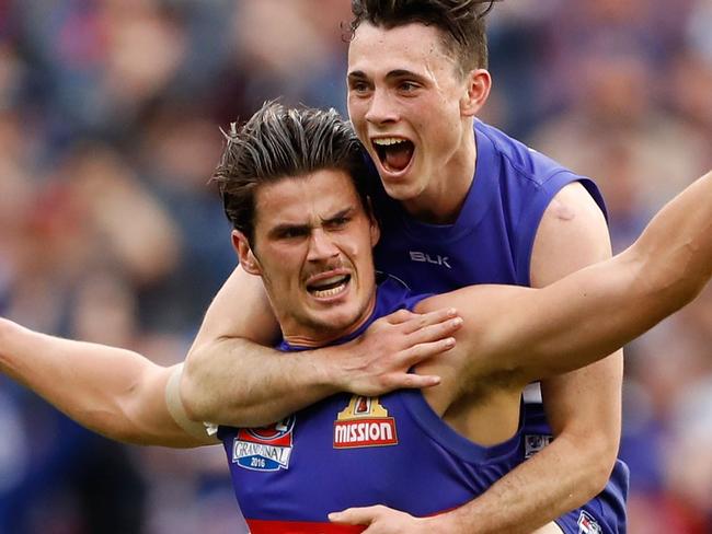MELBOURNE, AUSTRALIA - OCTOBER 01: Tom Boyd of the Bulldogs celebrates a goal with Toby McLean of the Bulldogs during the 2016 Toyota AFL Grand Final match between the Sydney Swans and the Western Bulldogs at the Melbourne Cricket Ground on October 01, 2016 in Melbourne, Australia. (Photo by Adam Trafford/AFL Media/Getty Images)