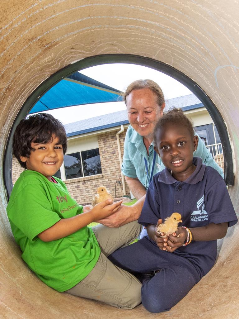 Both the students and teachers at Darling Downs Christian School are excited to learn and grow in their new kindy facilities. Kindy students (from left) Gavin Chaudhary and Nyibol Jok with their kindy teacher, Robyn Crisp and brand new fluffy classmates, chicks Pumpkin and Risotto. Picture: Nev Madsen