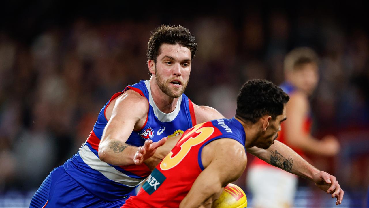 MELBOURNE, AUSTRALIA – JUNE 07: Bailey Williams of the Bulldogs attempts to tackle Charlie Cameron of the Lions during the 2024 AFL Round 13 match between the Western Bulldogs and the Brisbane Lions at Marvel Stadium on June 07, 2024 in Melbourne, Australia. (Photo by Dylan Burns/AFL Photos via Getty Images)