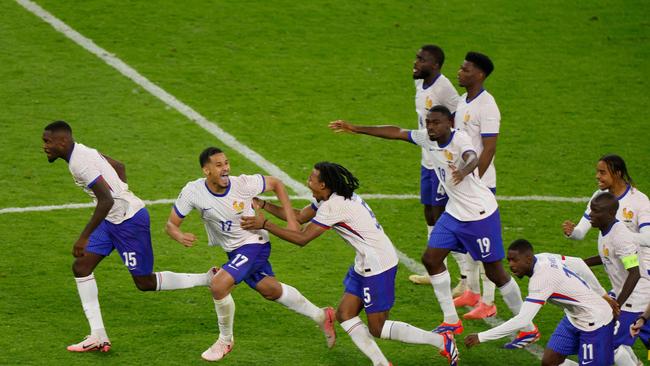 France's players celebrate after winning the UEFA Euro 2024 quarter-final. (Photo by Odd ANDERSEN / AFP)