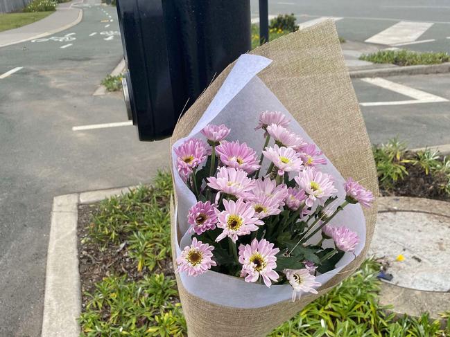 Flowers were left at the site of a crash in Nirimba which killed Broc Dawson and a motorcyclist.