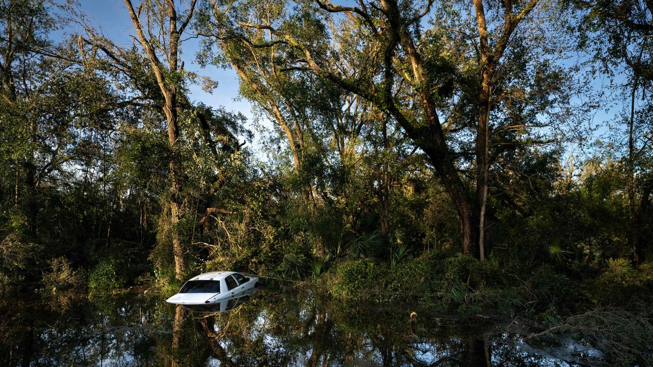 A vehicle that crashed after hitting a fallen tree sits in a gully after Hurricane Idalia crossed the state on August 30, 2023 in Perry, Florida. Picture: Sean Rayford Getty Images via AFP