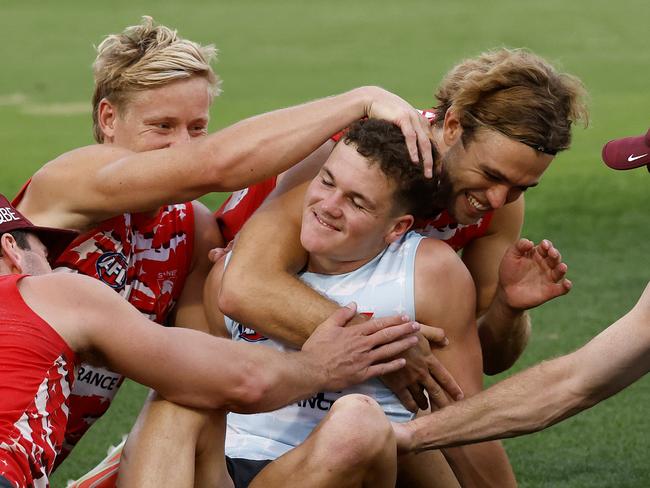 ** Embargo - 11.45 am today ** - Tom Hanily is congratulated after receiving the news from coach Dean Cox at training on Wednesday night that he will make his debut for the Swans against Hawthorn in the AFL Opening Round. Photo by Phil Hillyard (Image Supplied for Editorial Use only - **NO ON SALES** - Â©Phil Hillyard )