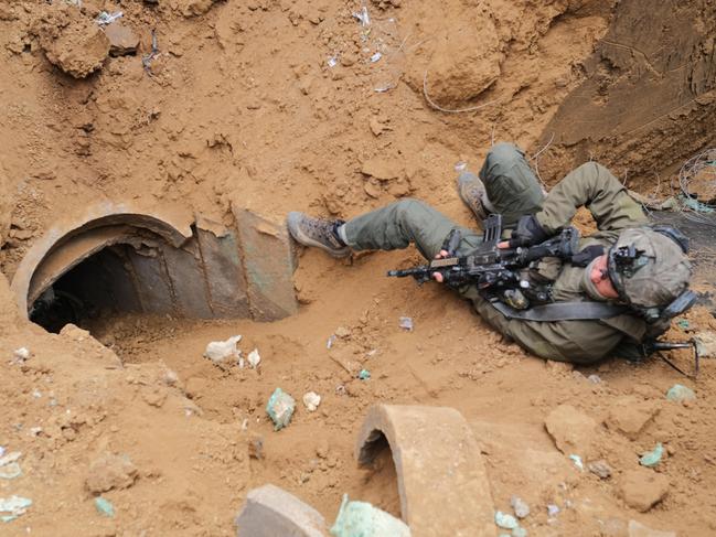 A soldier keeps guard over a tunnel shaft discovered by the IDF near the Israeli border. Picture: Yoni Bashan / The Australian