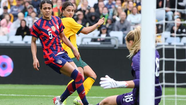 Sam Kerr (C) has a shot blocked.