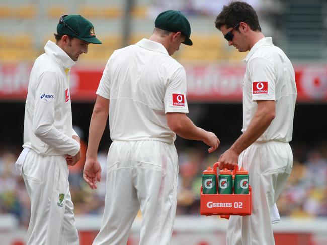 Ben Cutting runs the drinks on day one at the Gabba in 2011.