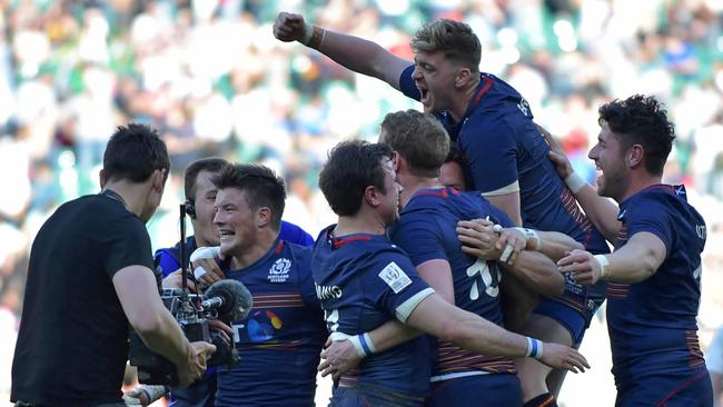 Scotland players celebrate on the pitch after their victory in the cup final match of the London Sevens.